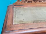 a wooden cabinet with a mirror on top of it