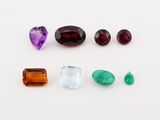 several different colored gems are arranged on a white surface
