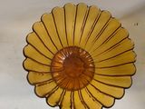 a glass bowl with a yellow flower on it