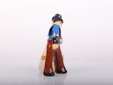 a small figurine of a man with a baseball bat in his hand