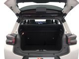the back of a white car with its trunk open showing the rear seats