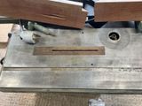 two pieces of wood on a table with a planer
