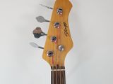 the neck of a bass guitar with a guitar pick up sticker attached to it