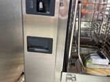 a large stainless steel dishwasher that is on a pallet