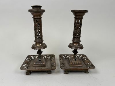 pair of antique brass candlesticks with ornate design