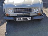 a silver car that is parked on the side of the road