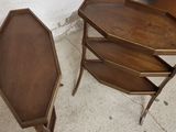 two wooden tables with a shelf on each side of them
