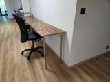 a desk with a chair and a computer on top of it