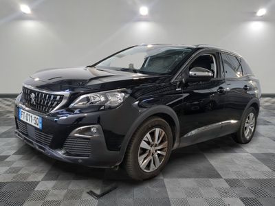 a black car parked in a room with a checkered floor