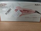 packaging of a babylis rose brush curler on a wooden table