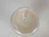 a candle that is sitting in a cup on a table