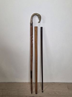 two canes that are standing next to each other on the floor