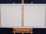 a easel with two white canvass on top of it