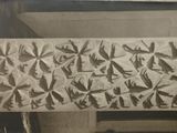 a picture of a stone slab with birds and birds on it