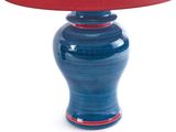 a blue table lamp with a red shade on it