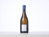 the bottle of white wine is sitting on the table