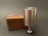 an image of a metal object with a wooden box in the background