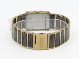 an image of a gold and black watch on a white surface