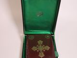 a small green box with a book inside of it