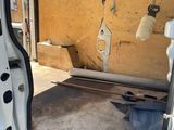 a white van with the door open in a yard