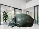 a sculpture of a skull on a table in a living room