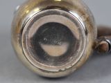 a close up of a silver vase on a table