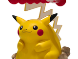 a yellow pokemon figurine with a red toothbrush on it