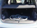 the trunk of a car with a bunch of wires in it