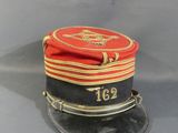 a red and black hat with a gold stripe on it