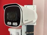 a camera mounted on a wall next to a red wall