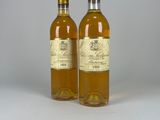 two bottles of wine sitting next to each other on a table