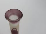 a purple glass vase with a heart on it