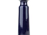 a blue vase that is sitting on a white surface