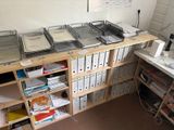 several trays of food sit on a wooden shelf in a room