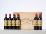 six bottles of red wine in a wooden box on a table