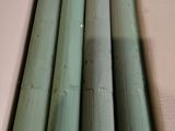 a cardboard box that has a bunch of green pipes in it