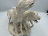 a statue of a dog and a cat on a table