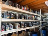 many different types of motor oil on shelves in a garage
