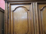 a wooden cabinet with a mirror on it in a room