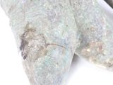 a close up of a stone object on a white surface