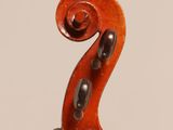 an old violin with a long neck and a long tail