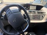 the interior of a car with a steering wheel and dashboard controls