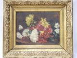 une image représentant un tableau de fleurs dans un cadre doré