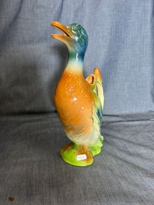 a figurine of a duck on a blue background