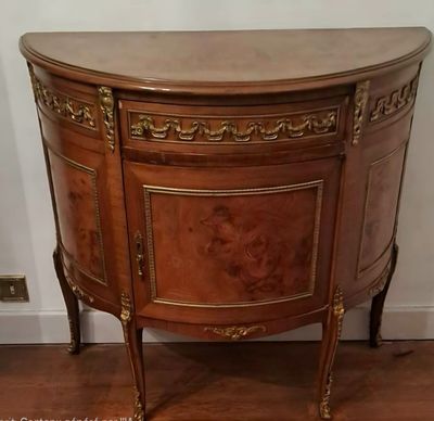 une armoire en bois avec un plateau en marbre posée sur un parquet en bois massif