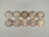 six different indian coins sitting on top of each other on a white surface