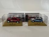 two toy cars in a display case on a white surface