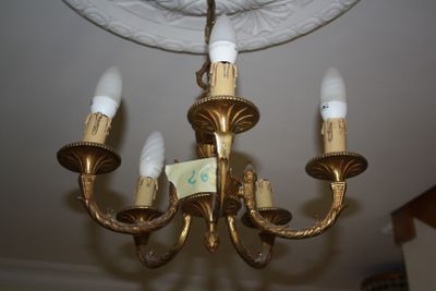 a gold chandelier with five lights hanging from the ceiling