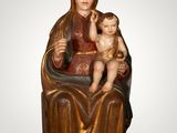 a statue of a woman holding a child in her lap
