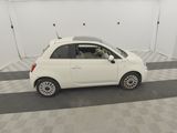a picture of a small white car parked in a garage